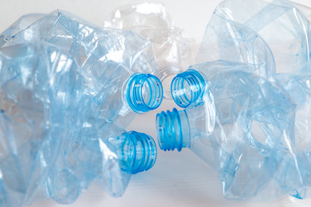 Crushed or crumpled clear plastic bottles. Plastic waste. Plastic recycling. Plastic pollution and...
