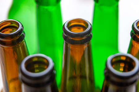 Necks of empty bottles, photographed closely. Use and reuse of glass. Waste and recycling.の写真素材