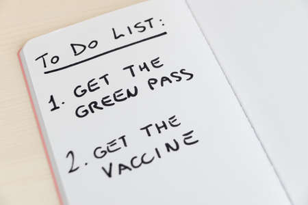 Blank diary page, with text "To do list", "get the green pass" and "get the vaccine". Need to obtain the vaccination green pass, and have to receive the vaccine.の写真素材