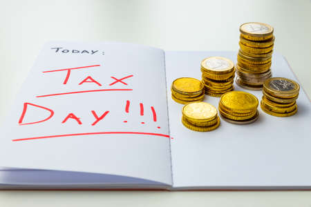 Page of diary or agenda, with the text "today ... tax day", and money next to it. Deadlines and tax obligations. Tax increase.の写真素材