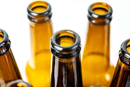 Necks of empty bottles, photographed closely. Use and reuse of glass. Waste and recycling.の写真素材