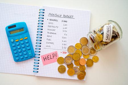 Notebook with monthly budget, calculator, help text and next to it a jar with coins. Rising prices...