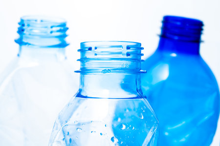 Plastic bottles, blue and transparent, crushed. Waste and plastic pollution, plastic recycling.の写真素材
