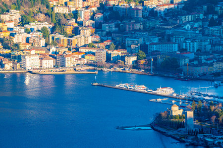 The city of Como, the lake, the lakeside promenade, the buildings, photographed from above.の写真素材