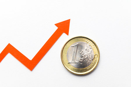 1 Euro coin, next to growing line. Valuation of the Euro and rising exchange rate.の写真素材