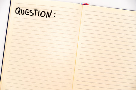 Blank notebook page, with the writing Questions, and marker next to it. Questions, answers and...