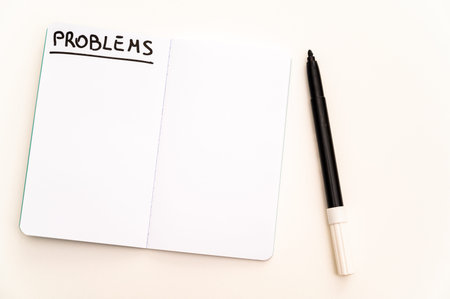 Blank notebook page, with the writing Problems, and marker next to it. Problems, solutions and...