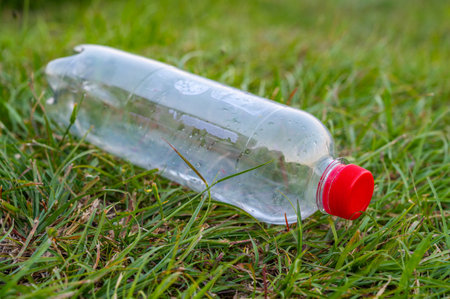 Plastic bottle abandoned in the environment. Plastic pollution and waste recycling.の写真素材
