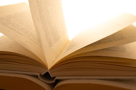 Open book on a white background, close-up, selective focusの写真素材