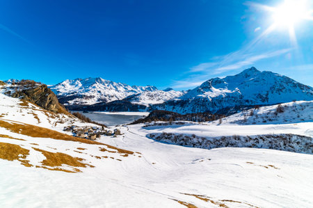 View of the village of Grevasalvas, and Lake Sils, in Engadine, Switzerland, in winter.の写真素材