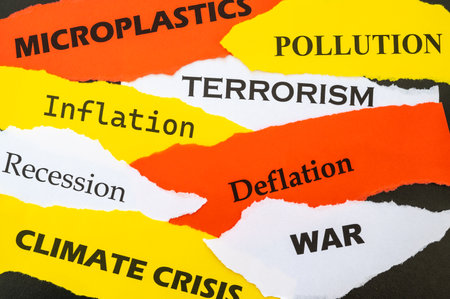 Current affairs, sheets of various colors with words: economic crisis, war, inflation, terrorism, etc., on a black background.の写真素材