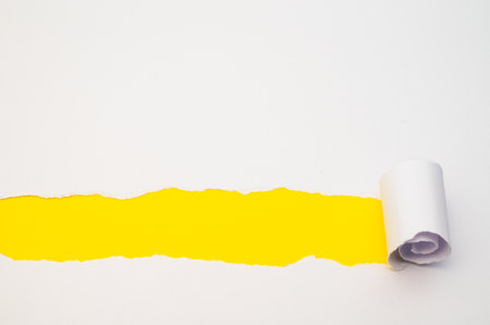 Colorful background, with torn and rolled white sheetの写真素材