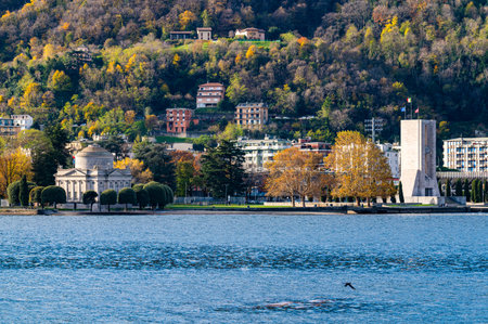 A view of the Como lakeside, with the Volta Temple and the War Memorial, in autumn.の写真素材