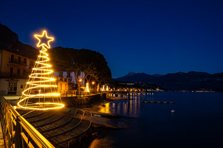 The lakeside of Lenno, on Lake Como, photographed at dusk, with Christmas lights and decorations.の写真素材
