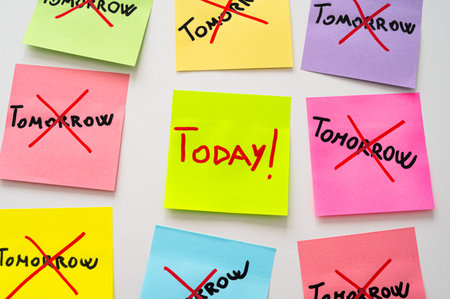 Colored card, with the word Tomorrow crossed out, and next to it cards with the word Today....
