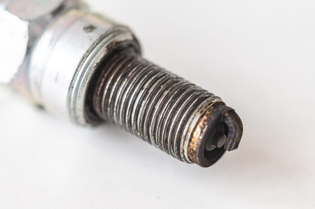 Spark plug for internal combustion engine, showing signs of use. Maintenance and care of the engine.