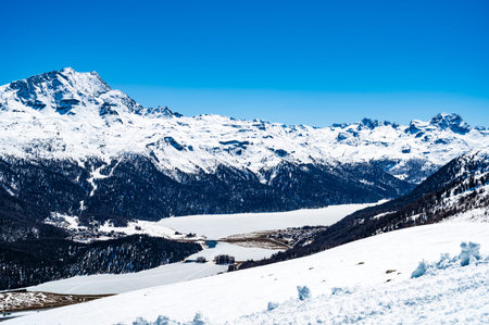 Panorama of the Upper Engadine and the lakes, with ski slopes and ski lifts, in ChampfÃ©re.