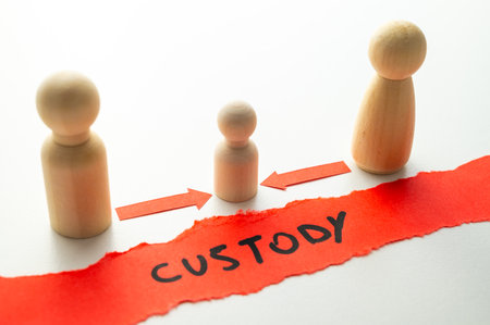 Concept of divorce and child custody dispute, expressed with wooden pieces, arrows, and the word "custody."の写真素材