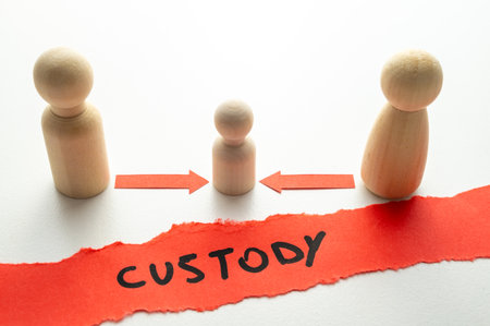Concept of divorce and child custody dispute, expressed with wooden pieces, arrows, and the word "custody."の写真素材