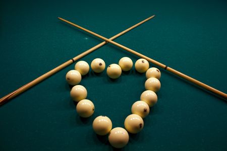 Billiard spheres on a table with green clothの写真素材