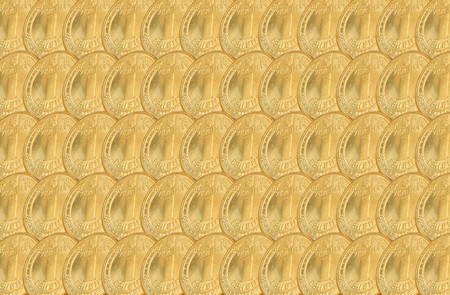 Background of gold colour consisting of coinsの写真素材