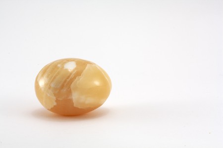 Lying yellow egg on white backgroundの写真素材