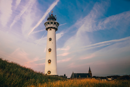 sea netherlands sand lighthouse sunset egmond an zeeの写真素材