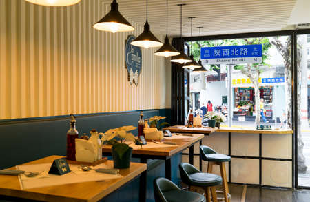 Shanghai - June 13, 2018: Shaanxi Road from the window of a local restaurant in Shanghai, interior design ideas for a simple modern cafe in Italian styleのeditorial素材