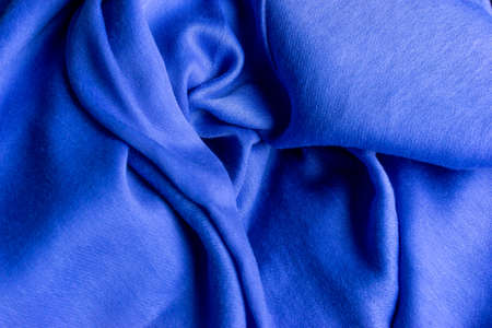 blue silk background, satin fabric, navy textile, flatlay of a blue clothing textile, sewing and fashion designの写真素材