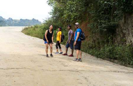 Namo Buddha, Nepal - September 20, 2020: A group of tourists walking in the countryside road in a village of Nepal, paddy fields in Asia, hiking tourのeditorial素材