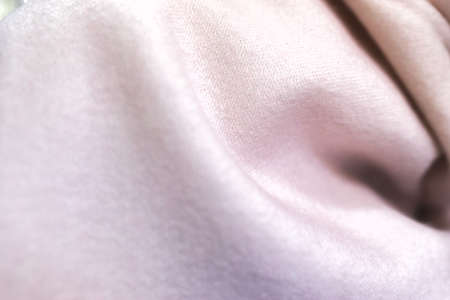 close up of a cashmere scarf, pink fabric, piece of clothing, woollen texture, clothing material, soft pink blanketの写真素材