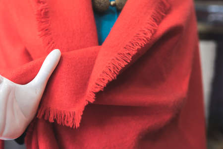 Red cashmere wool scarf, classic fashion, a hand of a white mannequin with red stoleの写真素材