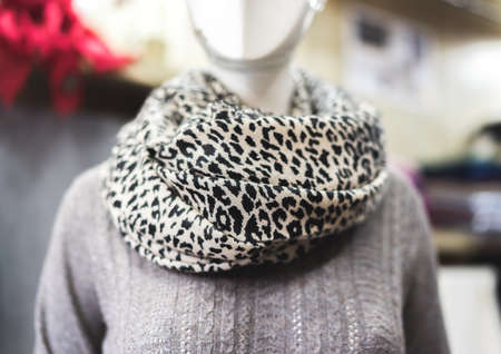 mannequin with leopard print scarf showroom with clothing fashion industry pure cashmere products organic textile, animal print scarf on a mannequin in a showroom, beautiful bokeh, copy paste conceptの写真素材