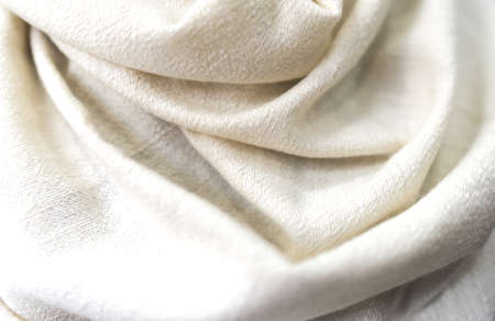 White beige towel texture. Closeup natural cashmere scarf. Light texture background, close up of a fabricの写真素材