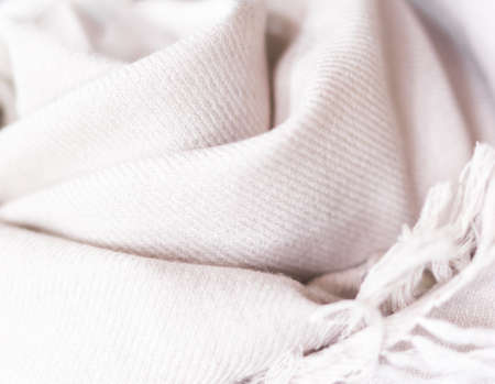close up of a cashmere scarf, pink fabric, piece of clothing, woollen texture, clothing material, soft pink blanket. Selective focusの写真素材