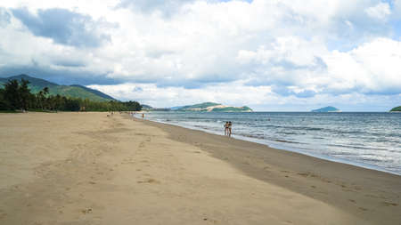beach with white sand on Hainan Island, sunny weather, summer travel vacation, fluffy white clouds in the sky, travel in China, beautiful beach with white fluffy clouds in the sky over the seaの写真素材