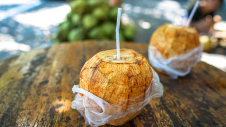 Sweet coconut on the table, refreshing coconut drink. Asian street fast food and drinks, healthy diet drink.の写真素材