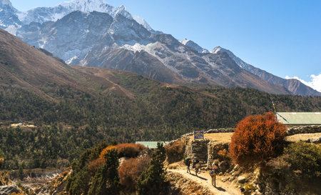 Dingboche, Nepal - October 2018: autumn in the mountains, beautiful landscape in the Himalayas, trekking to Everest Base Camp, snow peaks, tourists in the mountains, illustrative editorialのeditorial素材