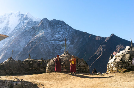 Tengboche, Nepal - October 2018: Two monks at Tengboche Monastery in Nepal, Buddhist landmark, trekking to Everest Base Camp, monks in the mountains, illustrative editorialのeditorial素材