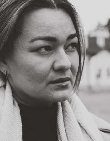 portrait of a beautiful serious woman, mature lady, black and white portrait, psychology and depression, negative thoughts, worried person, lonely Caucasian womanの写真素材