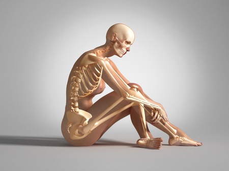 Naked woman sitting on floor, with bone skeleton superimposed. On neutral backgroundの写真素材
