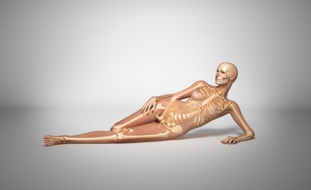 X ray looking, naked woman, laying down on floor, with bone skeleton superimposed, on neutral backgroundの写真素材