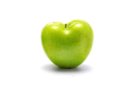 Green apple heart shaped. On white background.の写真素材