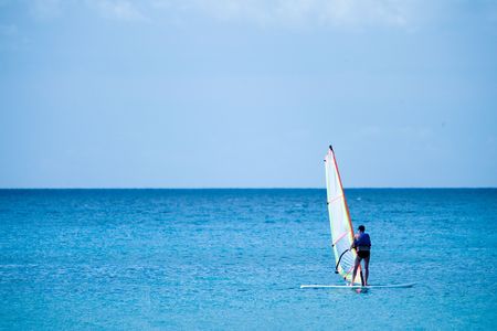 Someone wind surfing in the ocean on a beautiful dayの写真素材