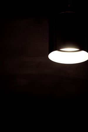 A dark room with one lightの写真素材