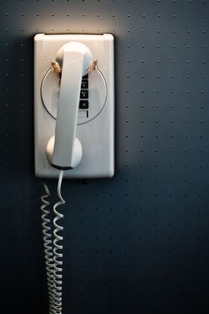 white telephone mounted on a wallの写真素材
