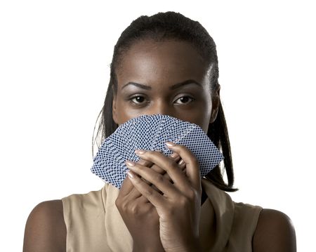 Young woman holding playing cards in front of her faceのeditorial素材