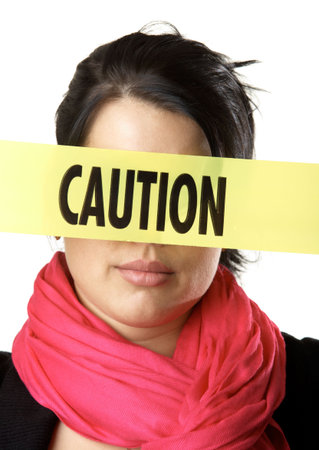 Young girl with a yellow caution tape isolated on a white background
