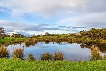 A dew pond on Ditchling Beacon in late autumnの写真素材