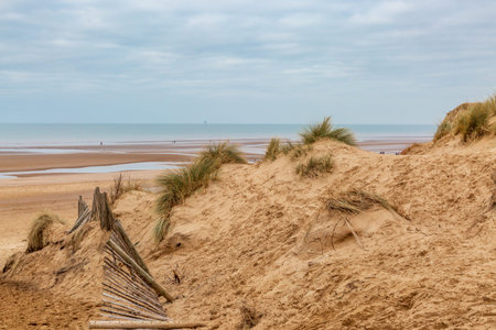 Looking out over sand dunes to the beach and sea